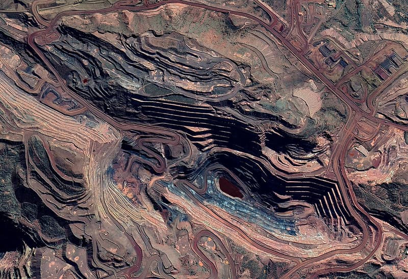Aerial view showing the grand scale and geological strata of an open-pit mine